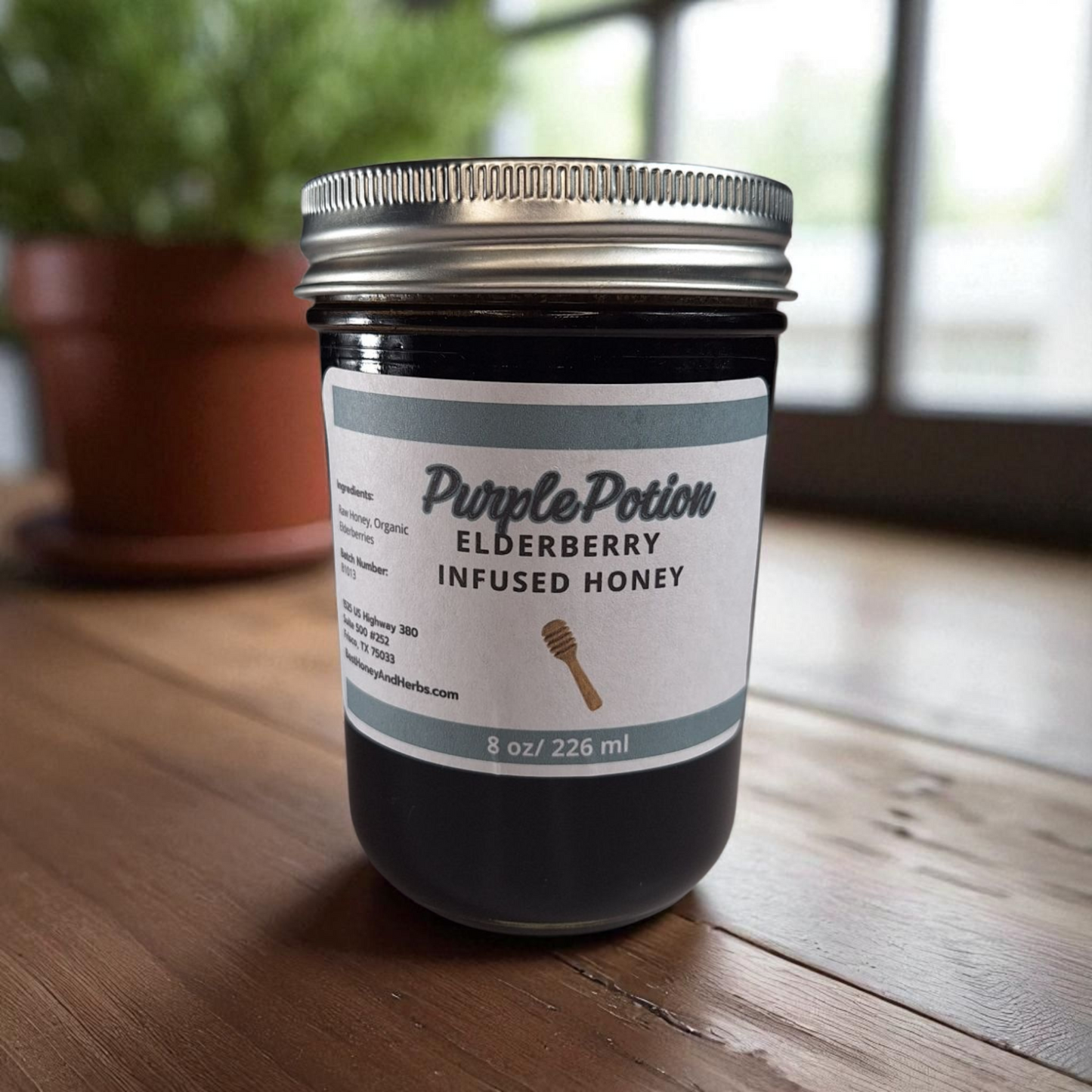 8 oz half-pint jar of raw Elderberry Infused Honey on a wooden surface, antioxidant-rich herbal sweetener for tea, baking, and wellness tonics.