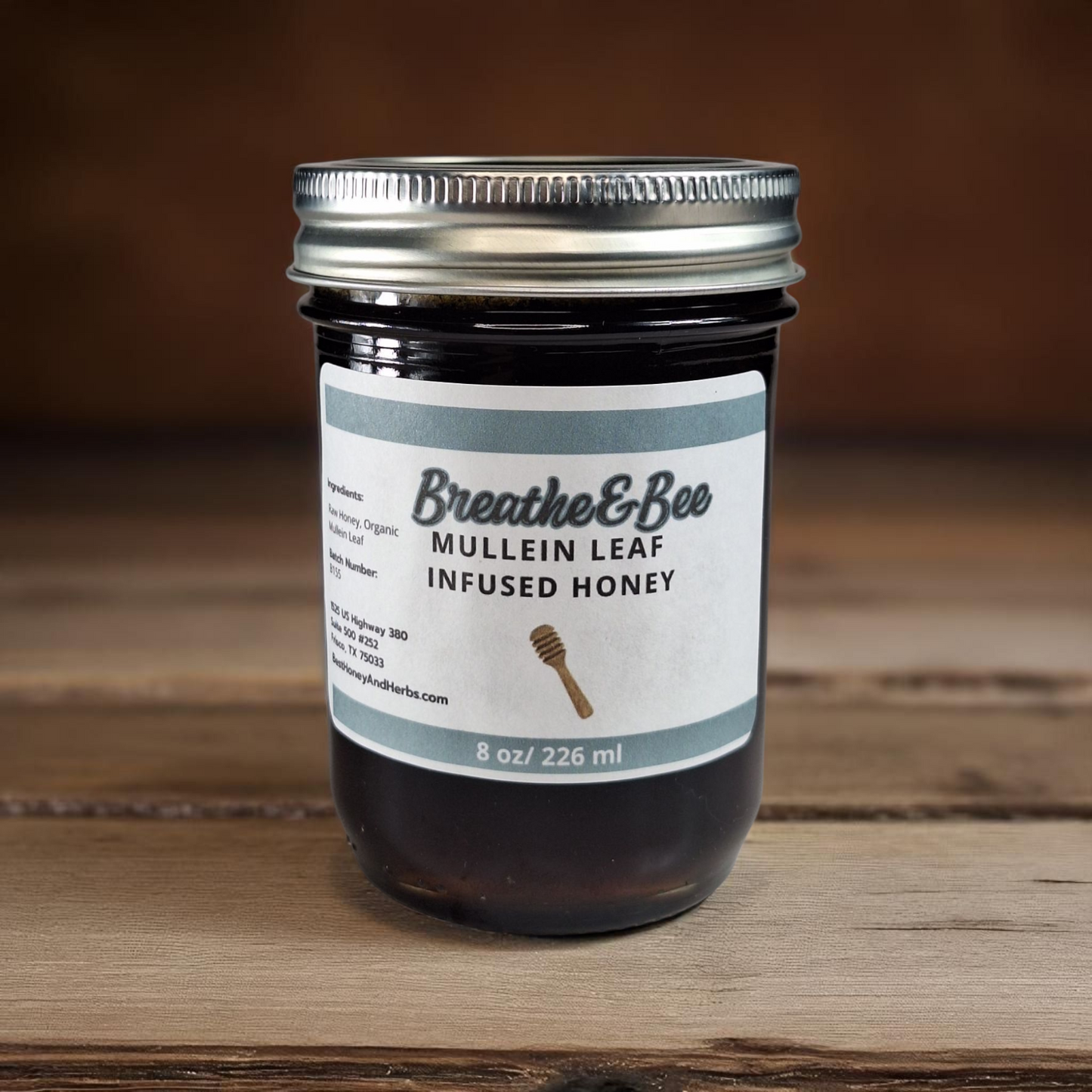 8 oz half-pint jar of raw Mullein Leaf Infused Honey on a rustic wooden surface, soothing herbal sweetener for tea, throat comfort, and natural wellness.