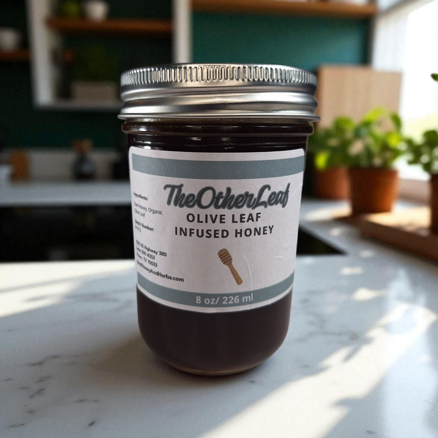 8 oz half-pint jar of raw Olive Leaf Infused Honey on a rustic wooden surface, herbal sweetener for tea, wellness tonics, and healthy recipes.
