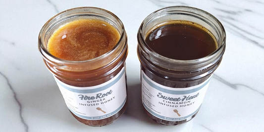 A jar of ginger infused honey and a jar of cinnamon infused honey