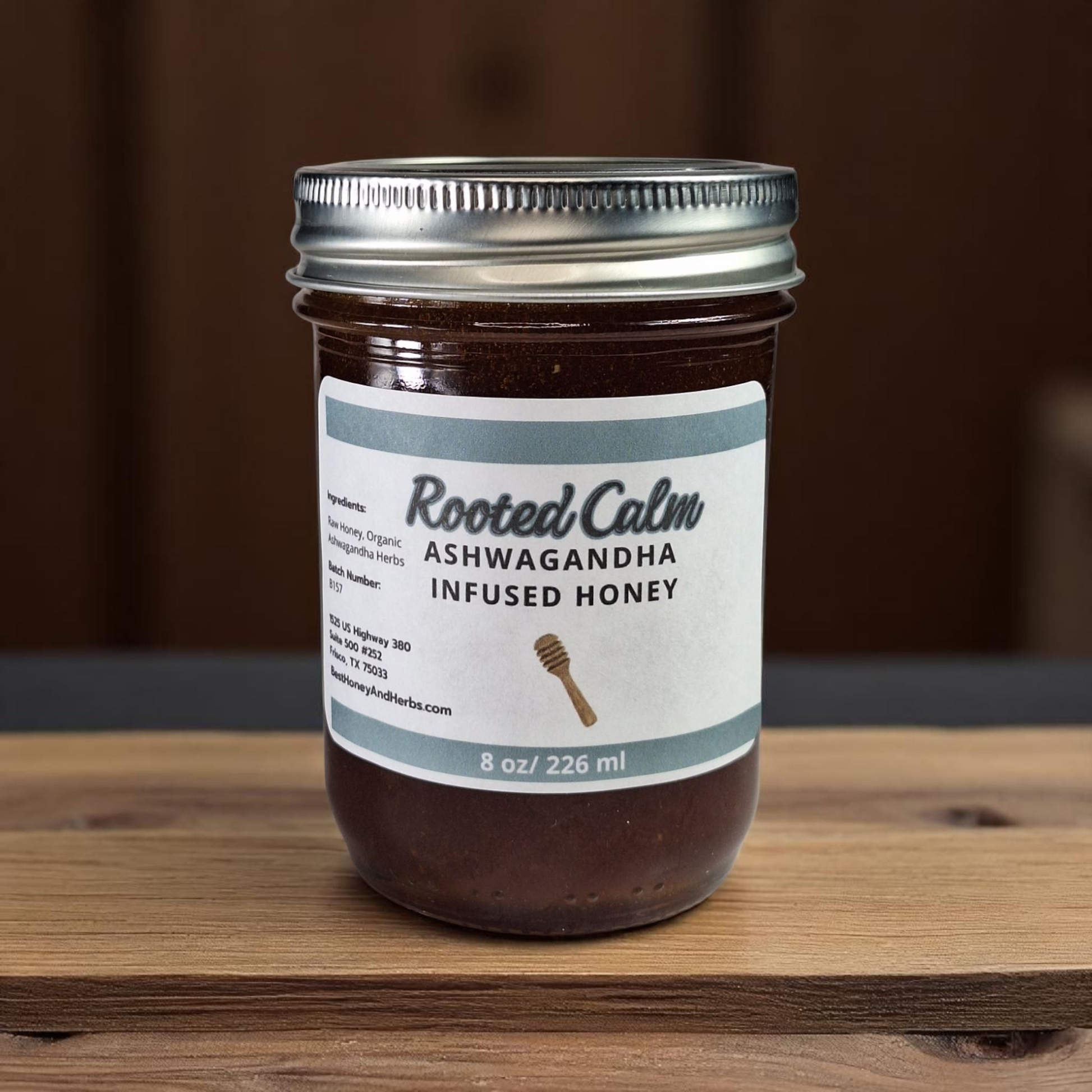 8 oz half-pint jar of raw Ashwagandha Infused Honey on a rustic wooden surface, small-batch herbal sweetener for tea, baking, and natural wellness.