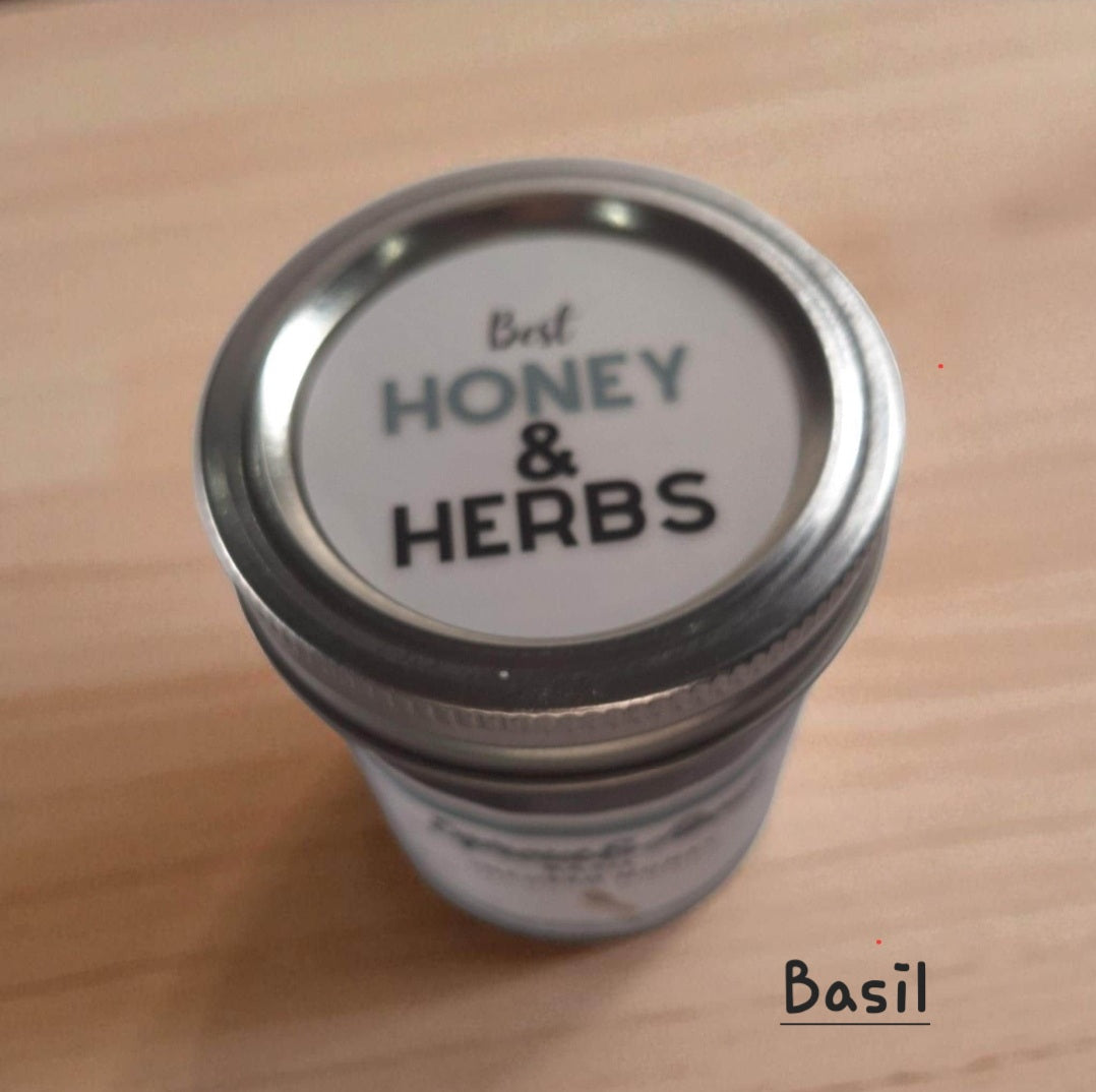 Top view of 8 oz half-pint jar of raw Basil Infused Honey on a wooden surface, herbal honey perfect for drizzling on bread, salads, or cheese.