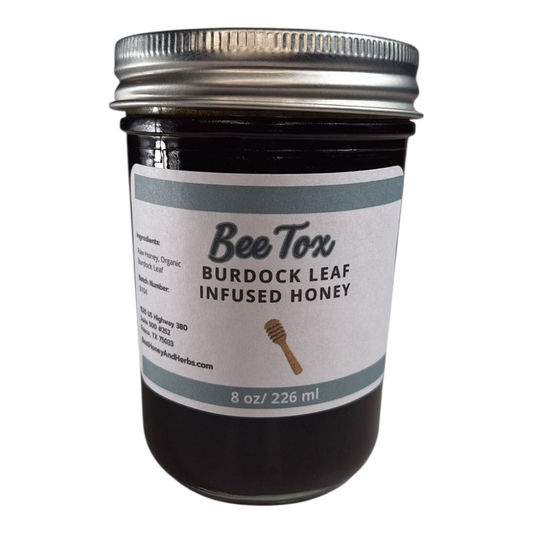 8 oz jar of raw Burdock Leaf Infused Honey, small-batch herbal sweetener for detox teas, tonics, and natural remedies, on a plain white background.