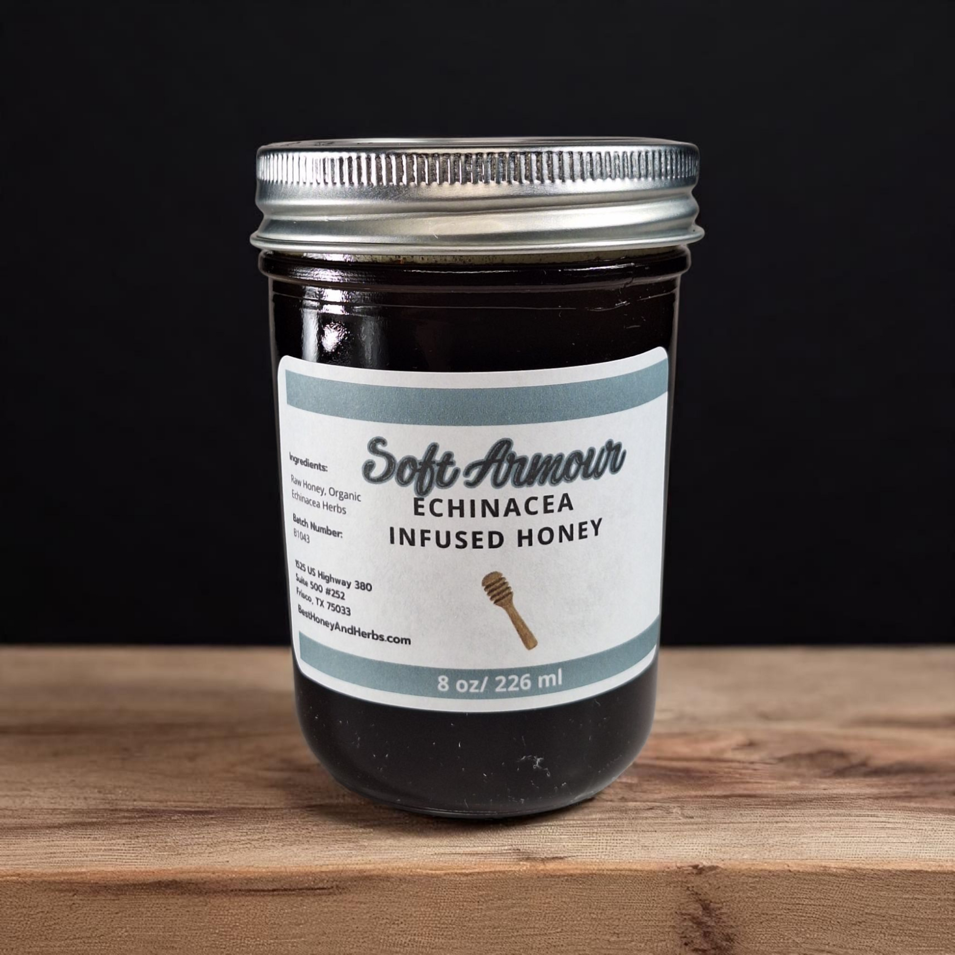 8 oz half-pint jar of raw Echinacea Infused Honey on a rustic wooden surface, herbal sweetener for tea, immune-support drinks, and healthy recipes.