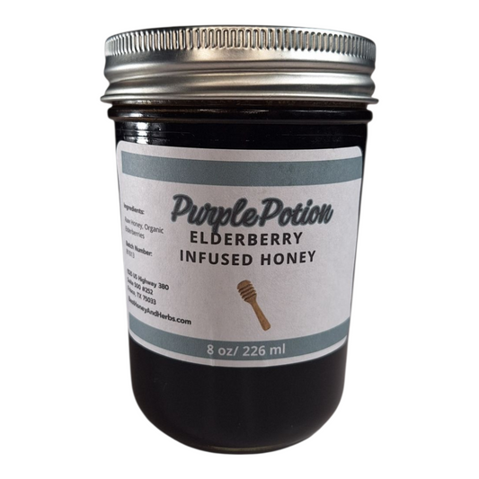 8 oz jar of raw Elderberry Infused Honey, antioxidant-rich herbal honey for tea, baking, and wellness tonics, on a plain white background.
