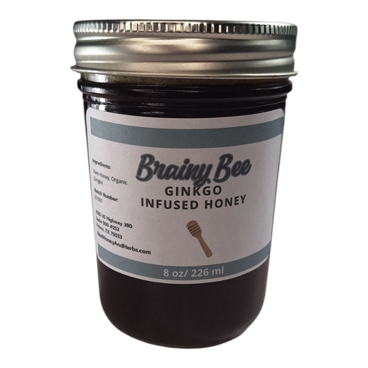 8 oz jar of raw Ginkgo Infused Honey, small-batch herbal honey for tea, memory support, and healthy recipes, on a plain white background.
