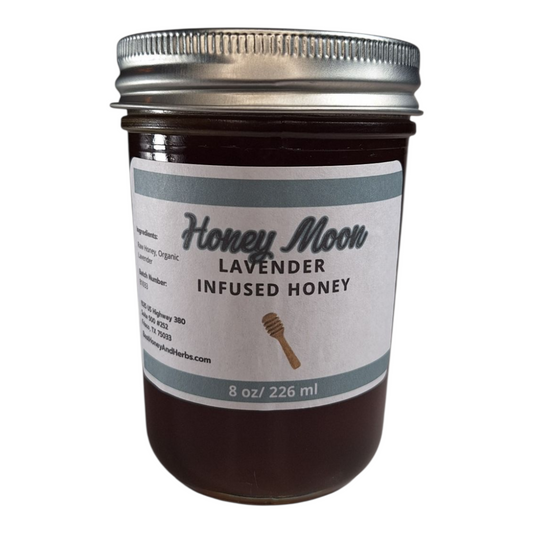 8 oz jar of raw Lavender Infused Honey, floral herbal sweetener for tea, baking, and relaxing drinks, on a plain white background.