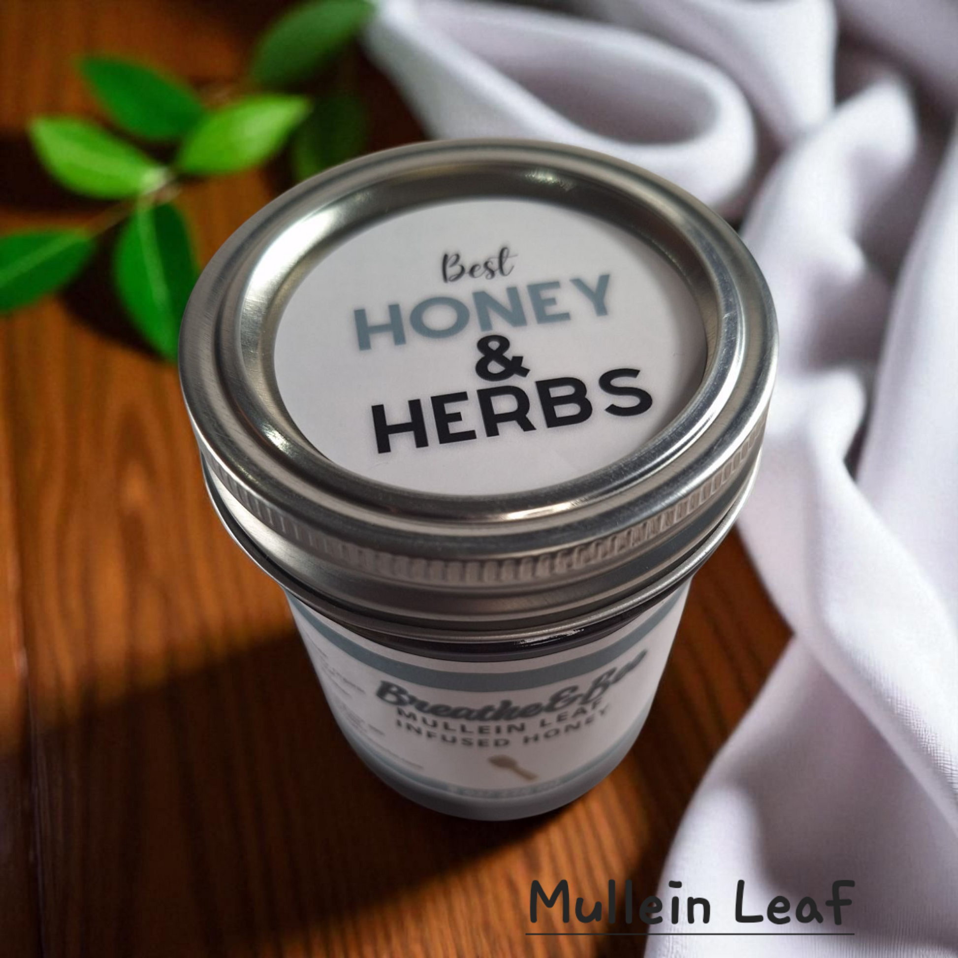 Top view of 8 oz half-pint jar of raw Mullein Leaf Infused Honey on a rustic wooden surface, soothing herbal sweetener for tea, throat comfort, and natural wellness.