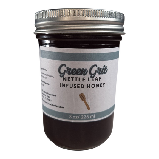 8 oz jar of raw Nettle Leaf Infused Honey, nutrient-rich herbal sweetener for tea, baking, and healthy recipes, on a plain white background.
