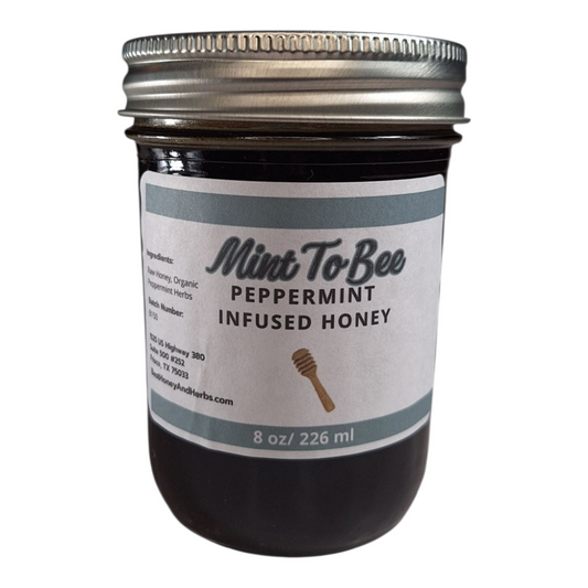 8 oz jar of raw Peppermint Leaf Infused Honey, refreshing herbal sweetener for tea, baking, and holiday treats, on a plain white background.