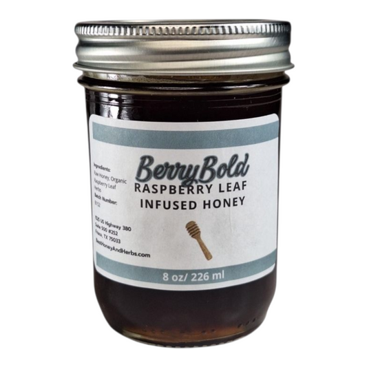 8 oz jar of raw Raspberry Infused Honey, fruity herbal sweetener for tea, desserts, and baking, on a plain white background.
