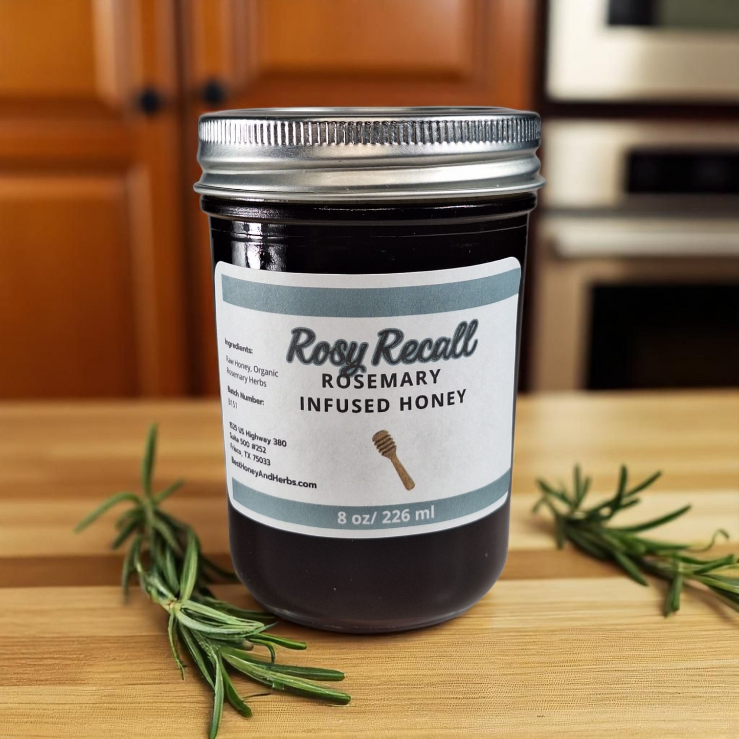 8 oz half-pint jar of raw Rosemary Infused Honey on a wooden surface, savory herbal sweetener for meats, bread, and roasted vegetables.