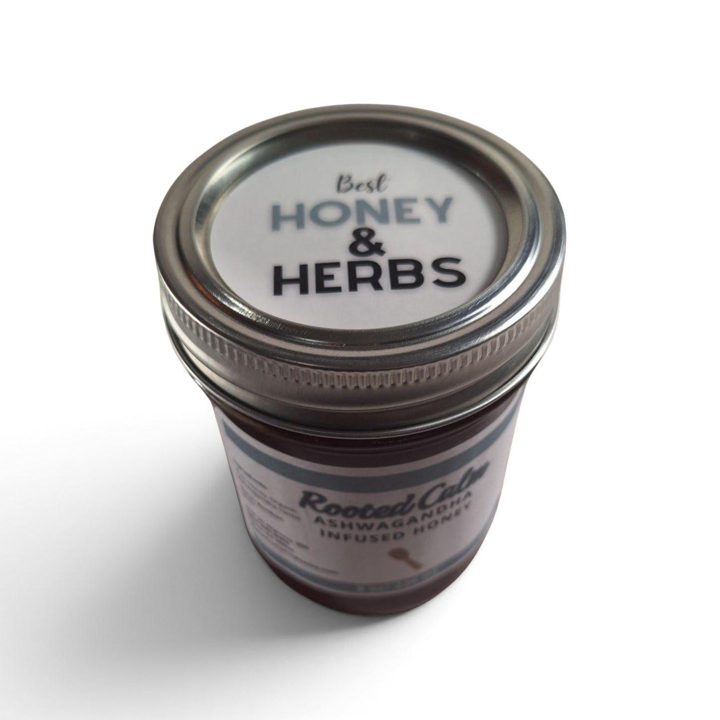  Ashwagandha infused raw honey half pint top down look at a glass jar with a metal lid.