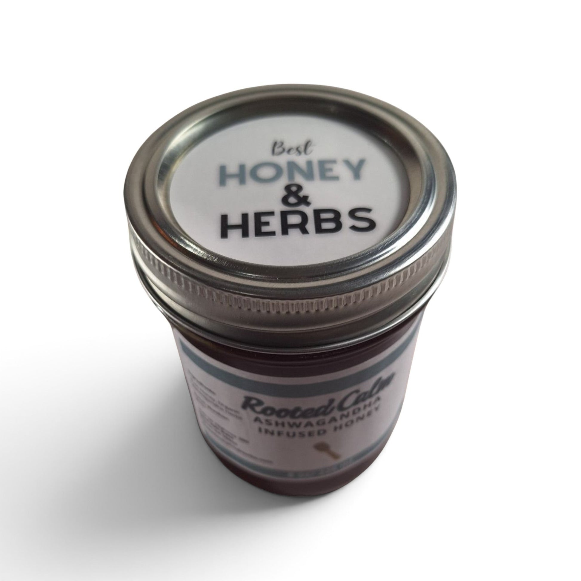  Ashwagandha infused raw honey half pint top down look at a glass jar with a metal lid.