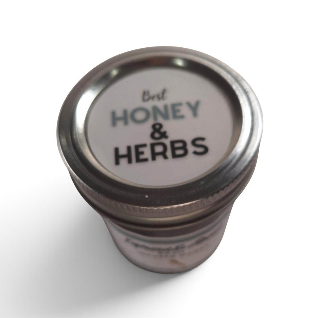 Basil infused raw honey in a glass mason jar with a metal lid.