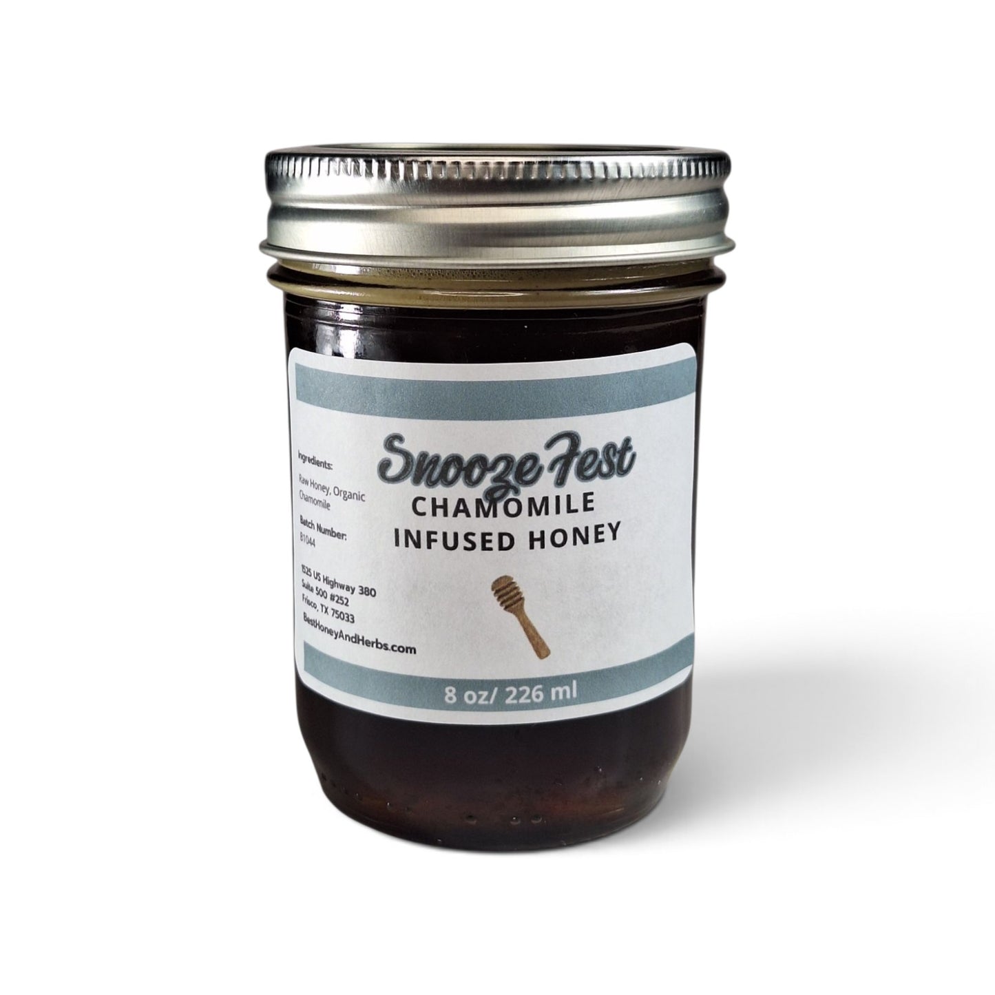  Chamomile infused raw honey in a glass jar with a metal lid for bedtime rituals.