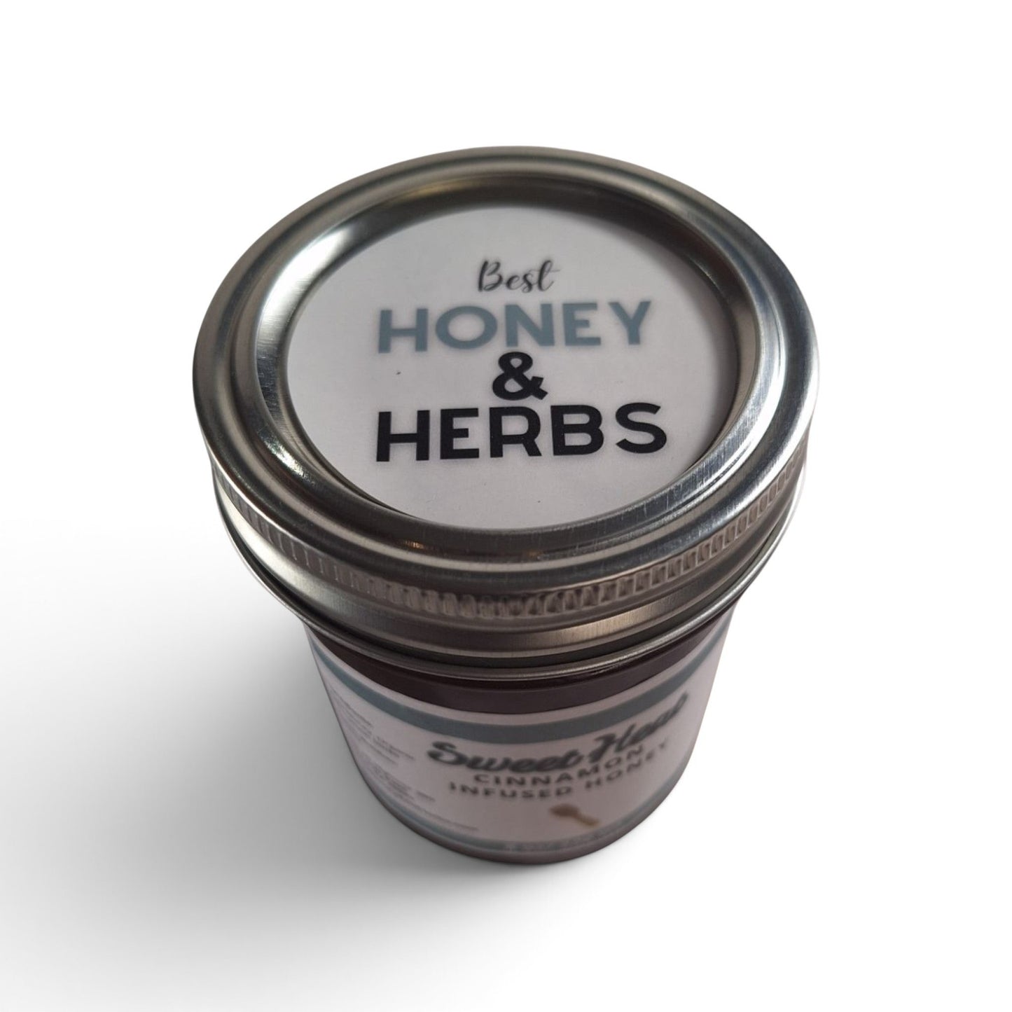 Cinnamon infused raw honey in a glass mason jar with a metal lid.