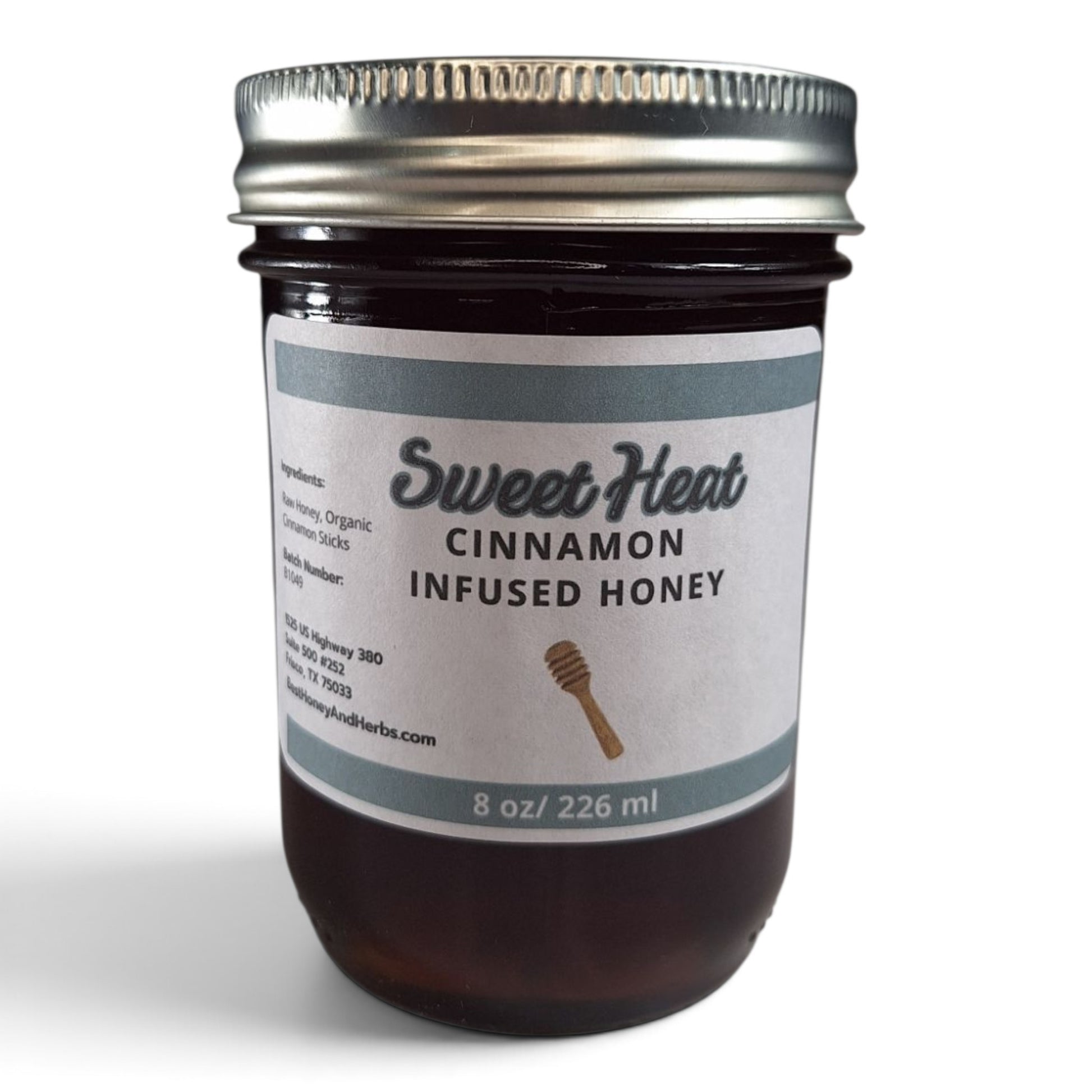 Cinnamon infused raw honey in an 8 oz glass mason jar with a silver lid.