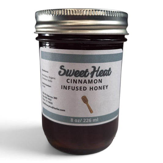Cinnamon infused raw honey in an 8 oz glass mason jar with a silver lid.