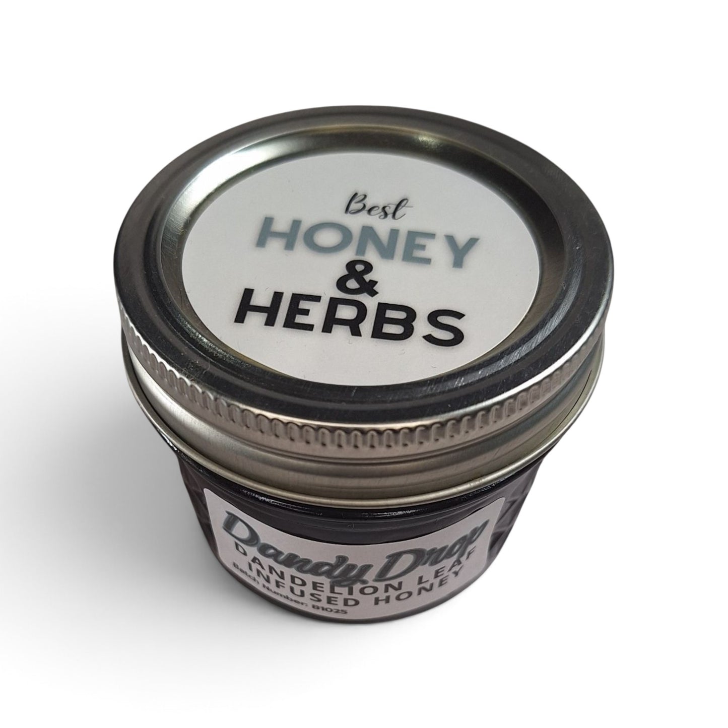 4 oz jar of raw honey infused with dandelion leaf, viewed from above.
