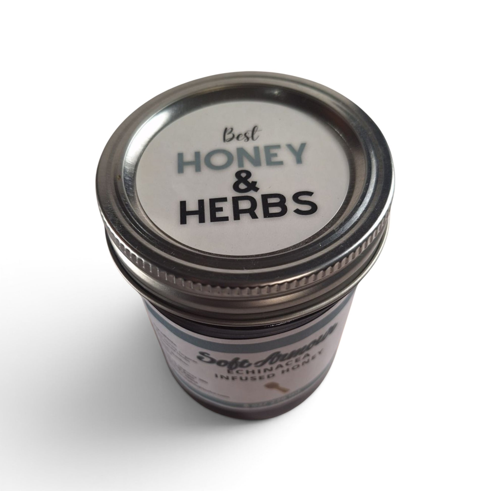  Echinacea infused raw honey in a glass jar with a metal lid, top-down view.