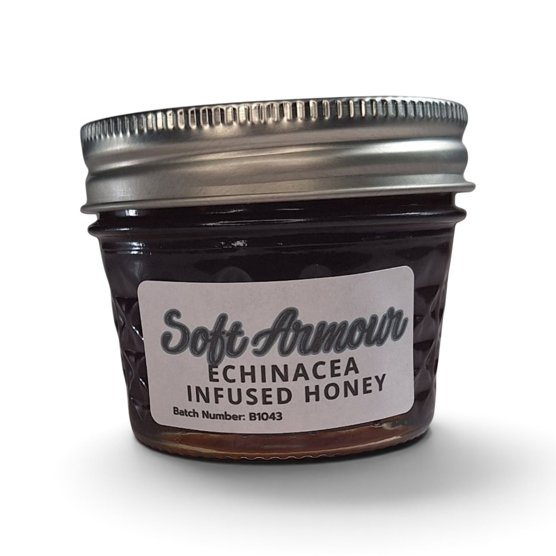  Echinacea infused honey in a small glass jar with a silver metal lid.