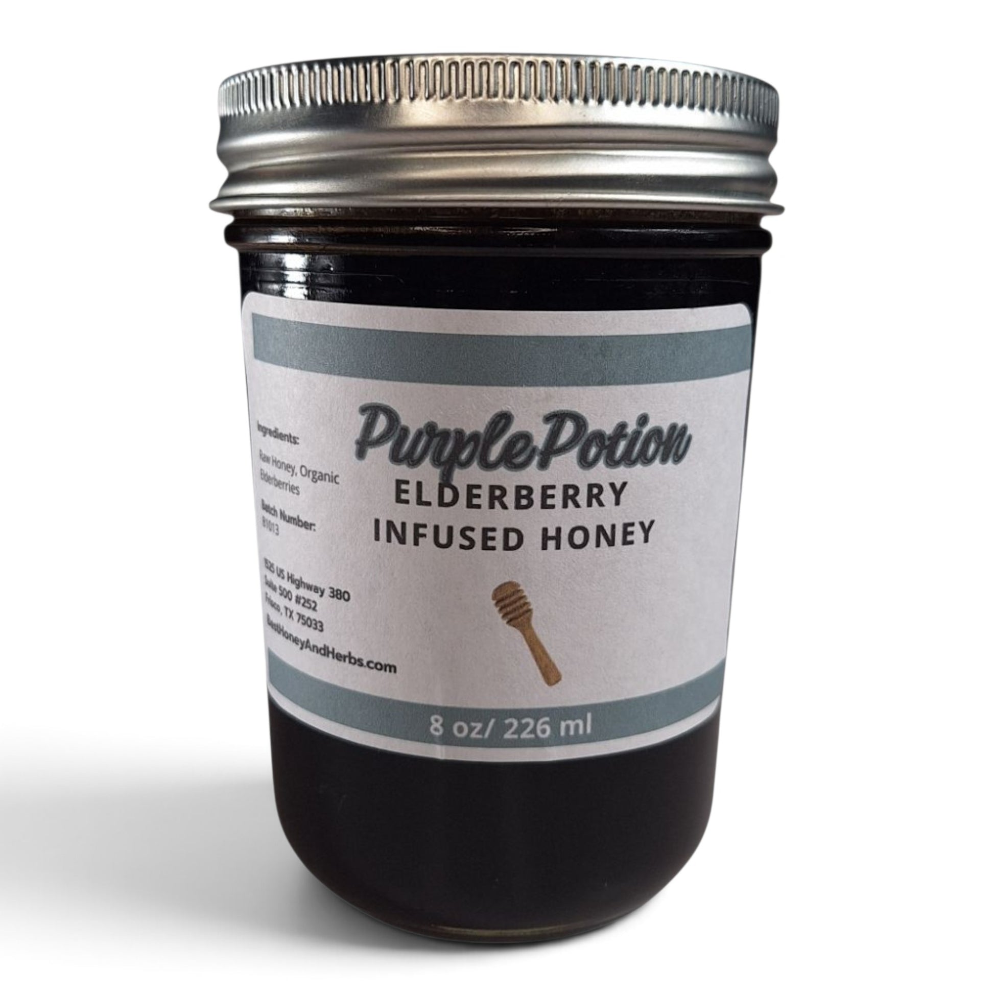 Elderberry infused raw honey in a glass mason jar with a silver lid.