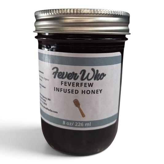  Feverfew infused raw honey in an 8 oz glass jar with a silver lid and minimalist, white label.