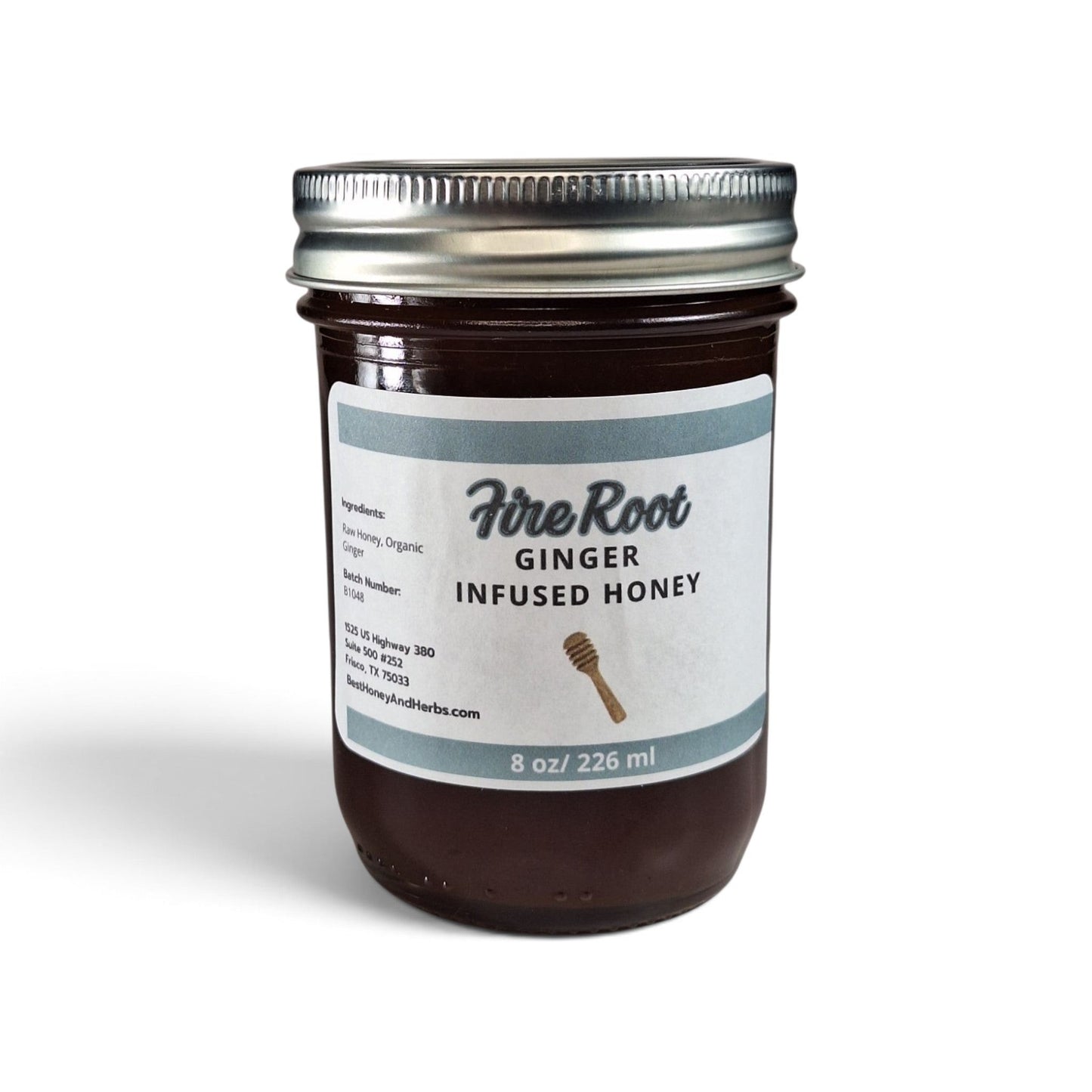 Ginger-infused raw honey in a 8 oz glass jar with a silver lid and white label.