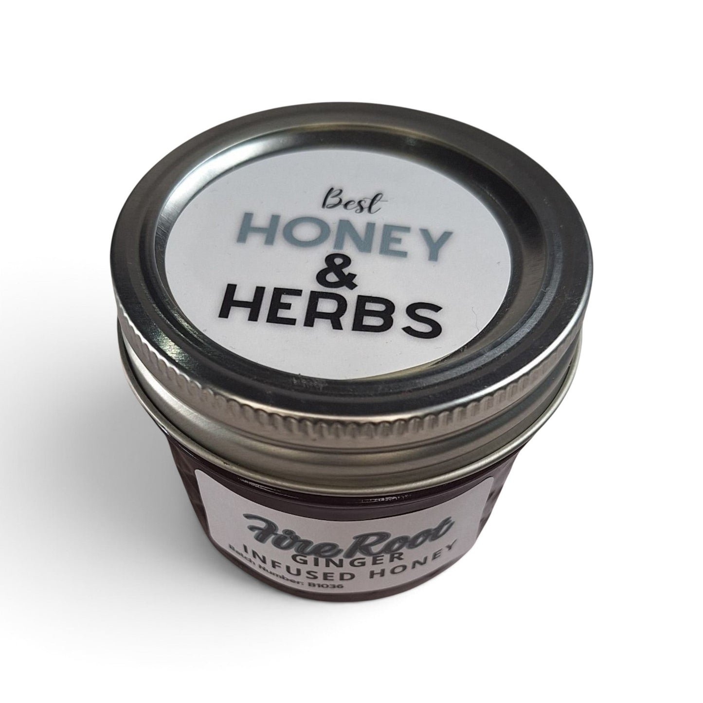 Ginger honey in a glass jar with a metal lid, viewed from above.