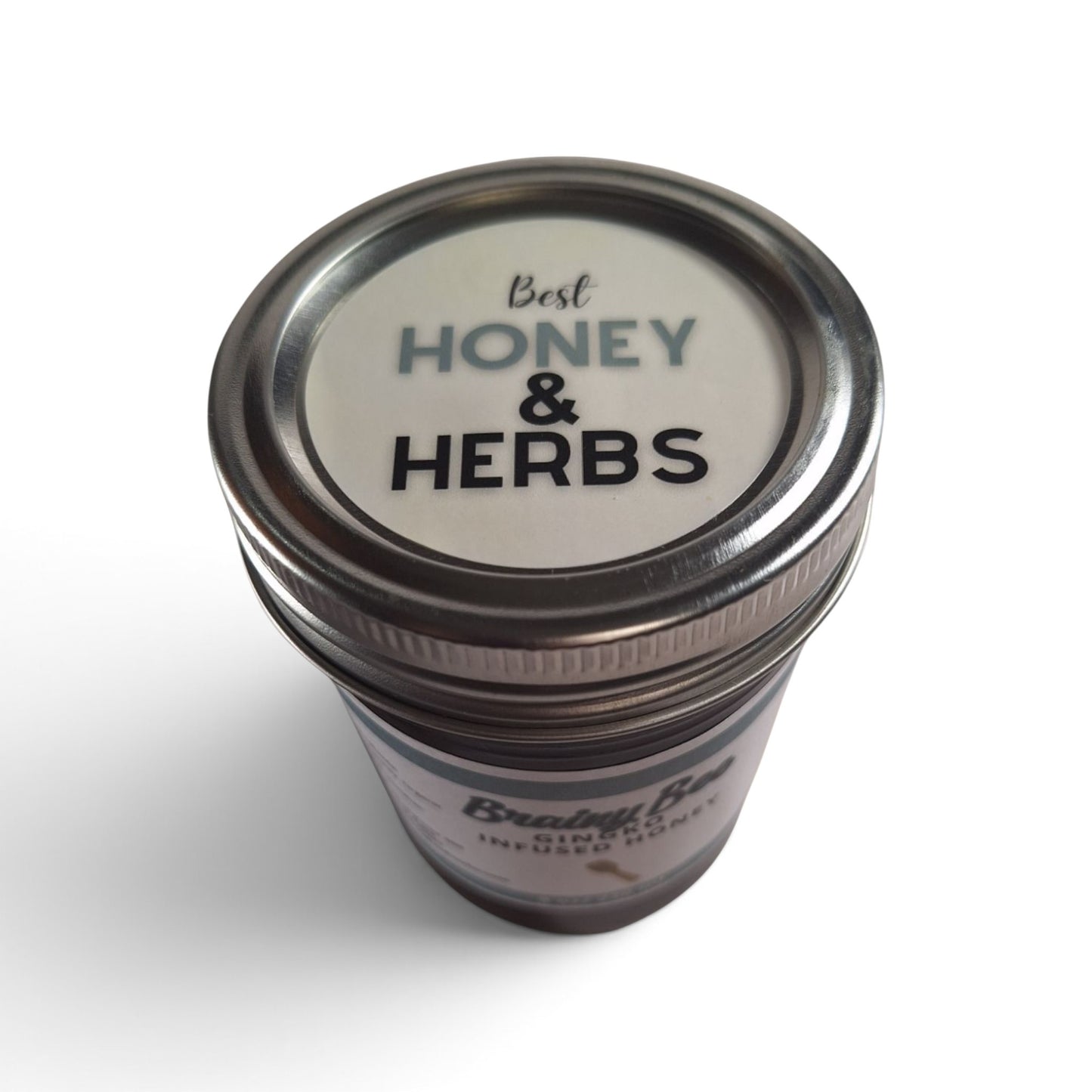  Ginkgo infused raw honey in a glass jar with a metal lid, viewed from above.