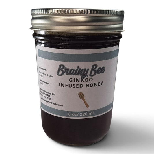 Ginkgo infused raw honey in a glass jar with a metal lid for cognitive support.