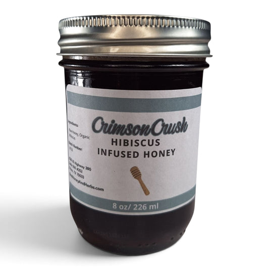  Hibiscus infused raw honey in a half pint glass jar with a silver lid.