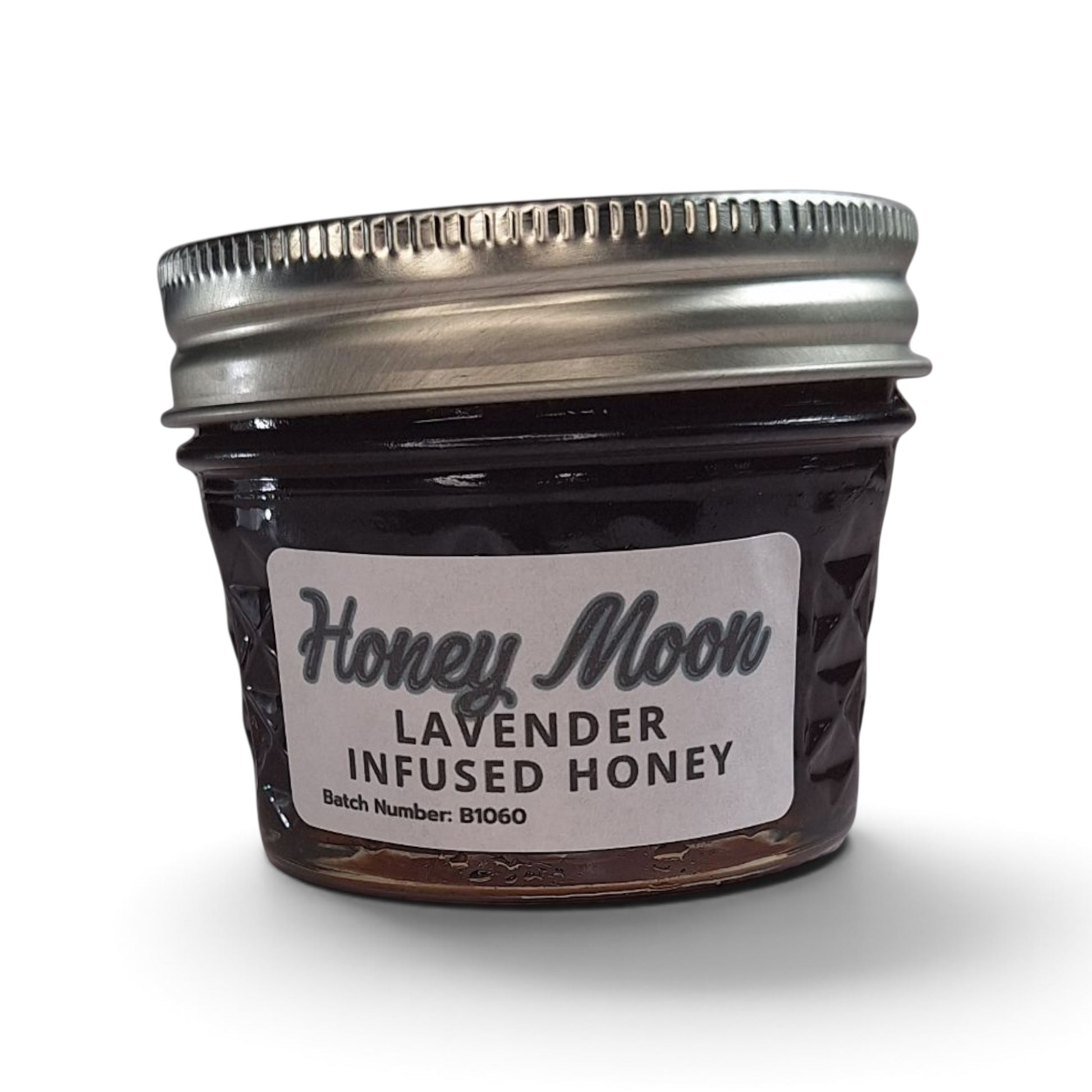  Lavender infused  honey in a small glass jar with a metal lid.