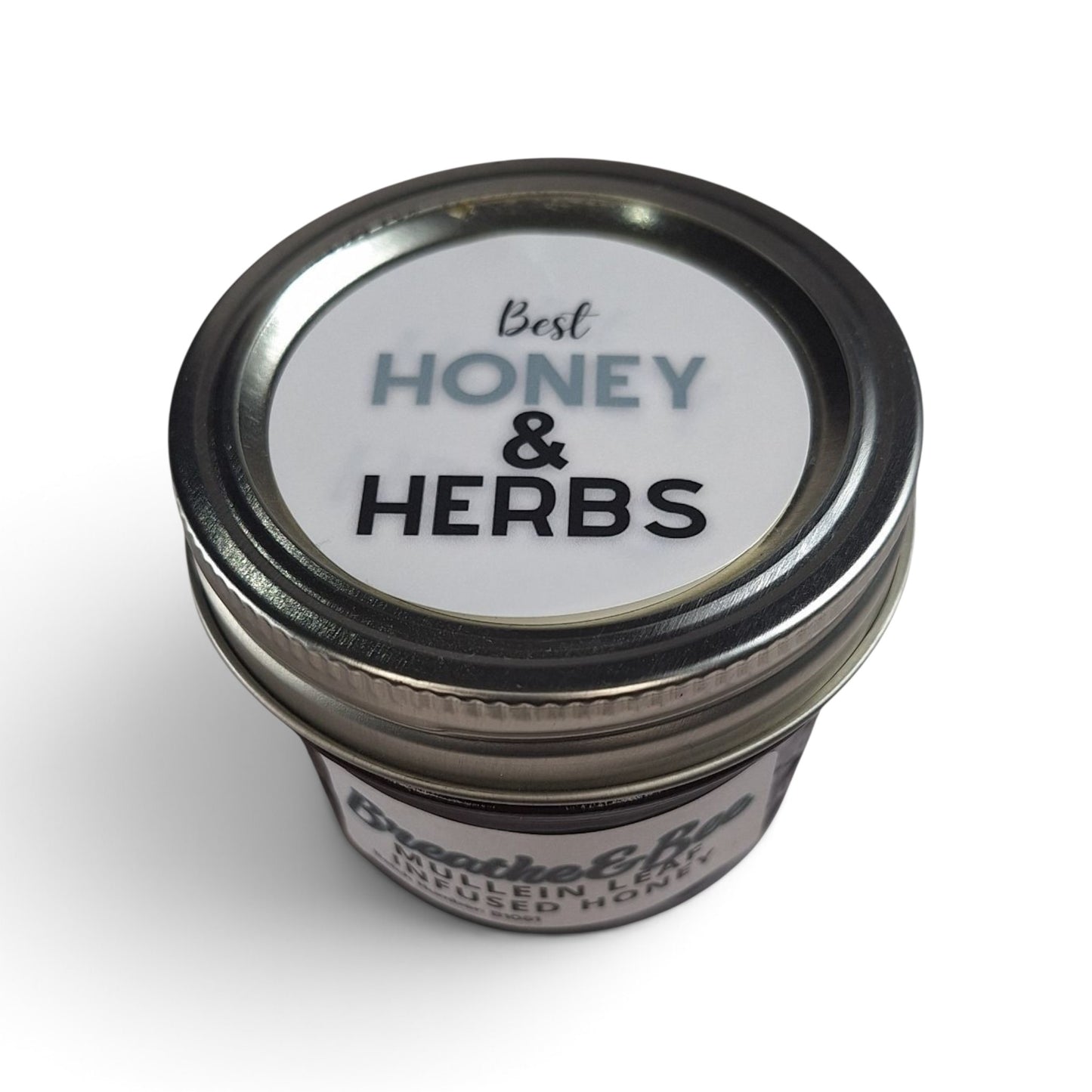  Mullein leaf infused raw honey in a small glass jar with a metal lid, top down view. 