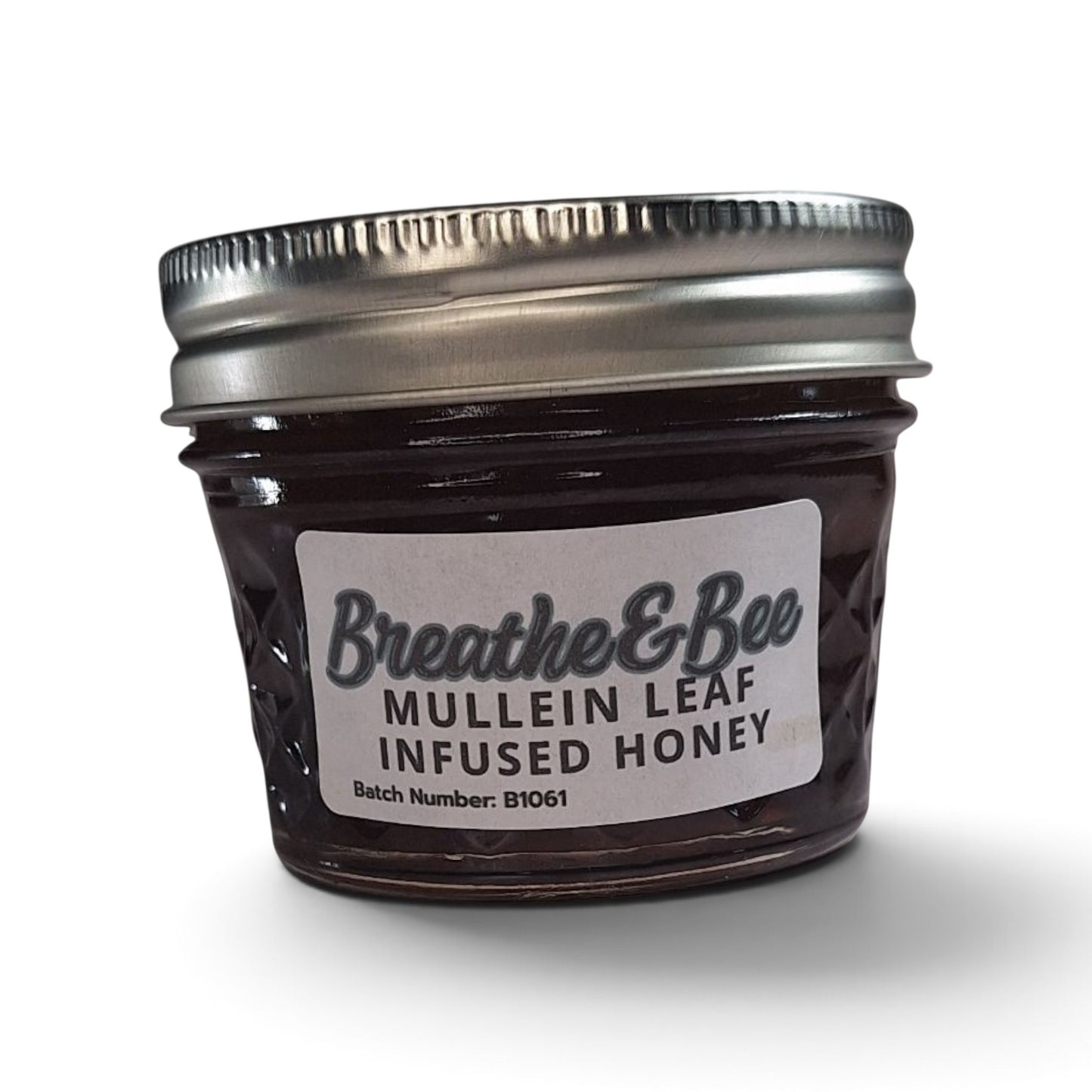  Mullein leaf infused honey in a small glass jar with a silver metal lid.