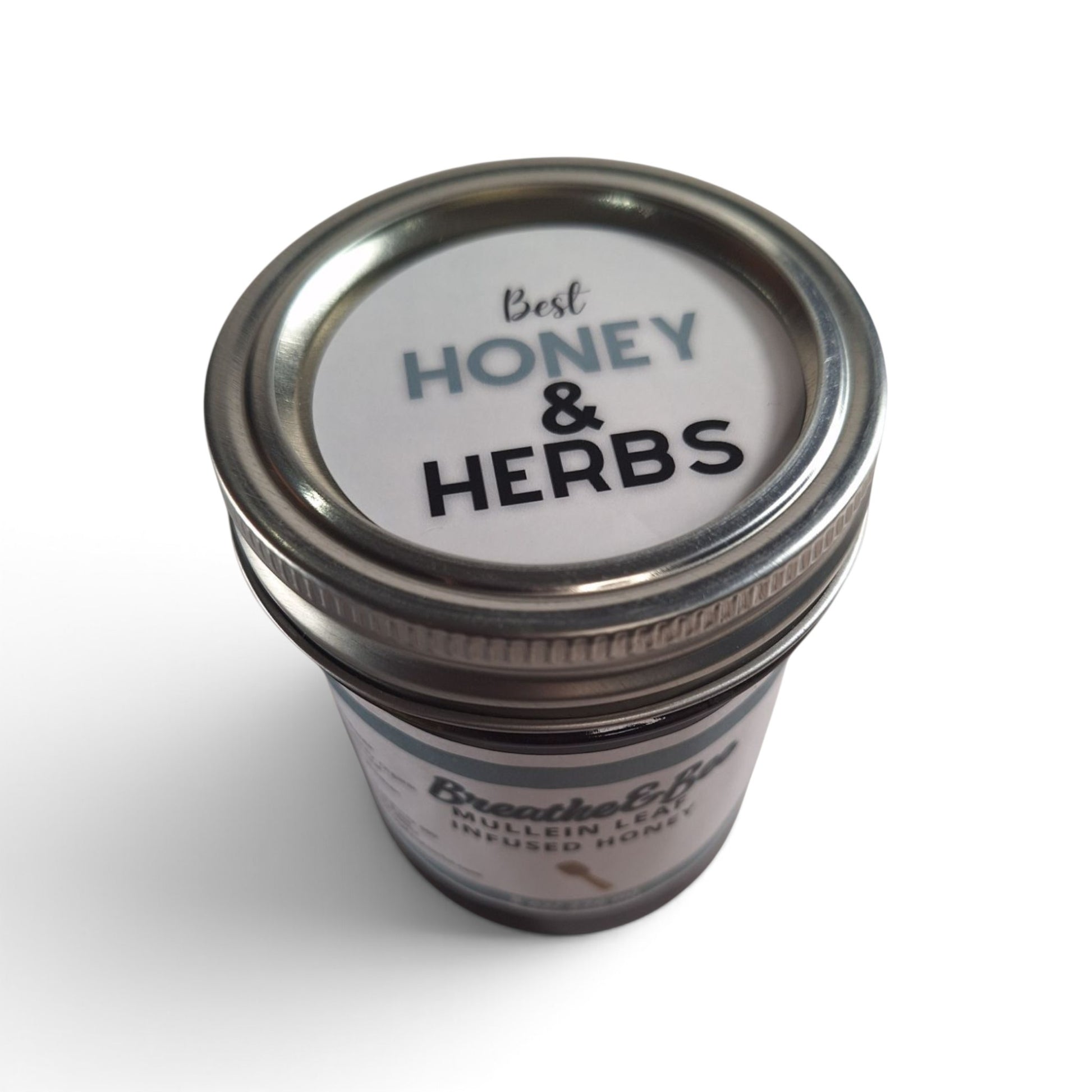  Mullein leaf infused raw honey in a glass jar with a metal lid, top-down view.