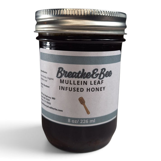 Mullein leaf infused raw honey in a half pint glass jar with a metal lid.