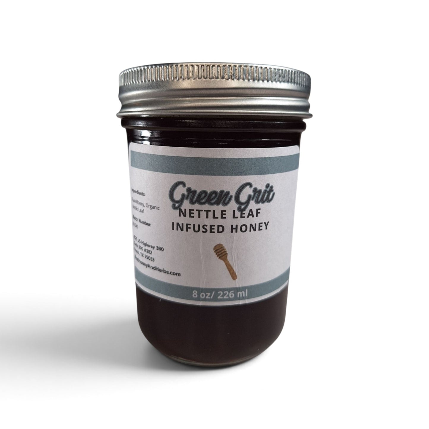 Best Honey and Herbs Green Grit nettle leaf-infused raw honey in a glass jar with a metal lid.