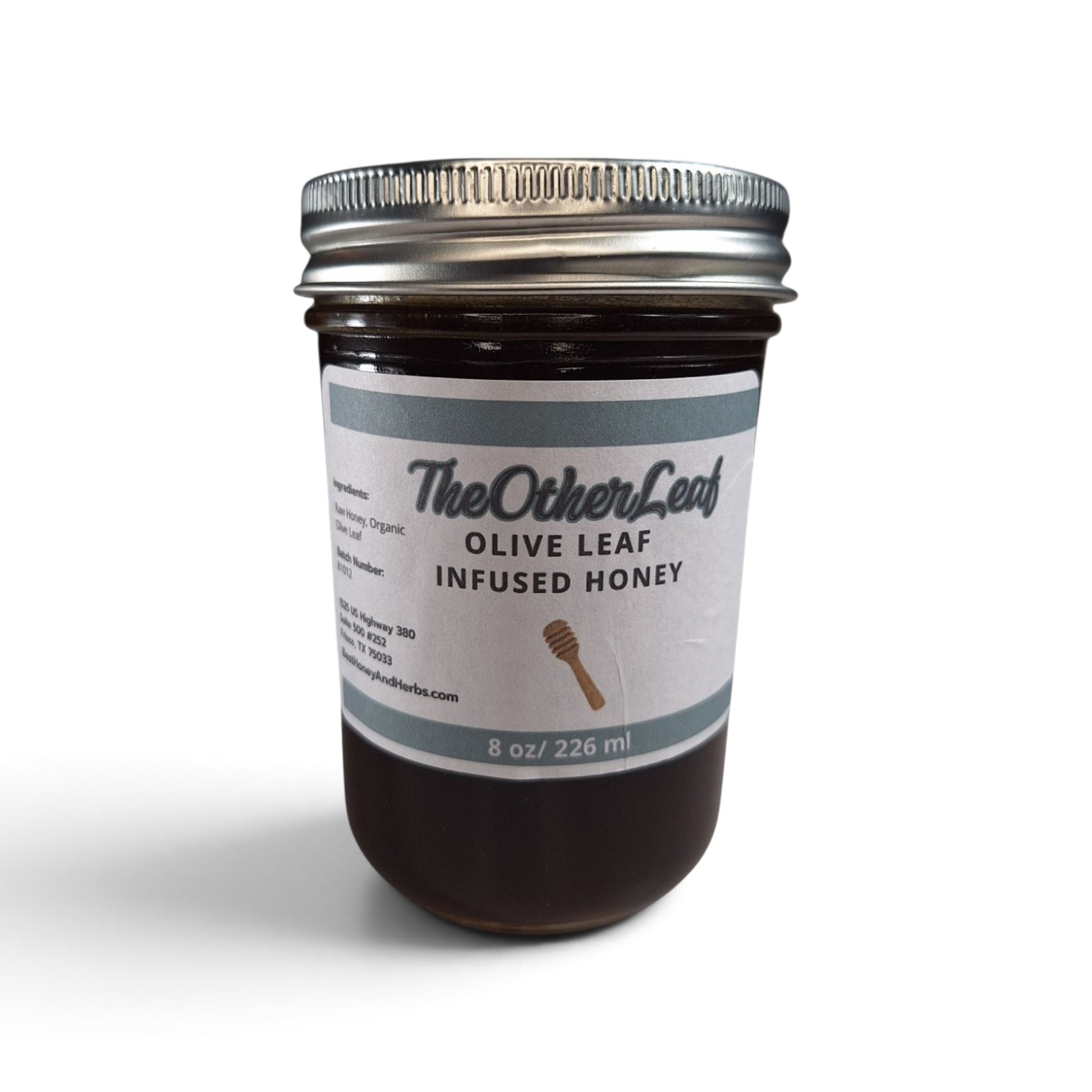 Olive leaf honey in a glass jar with a metal lid.