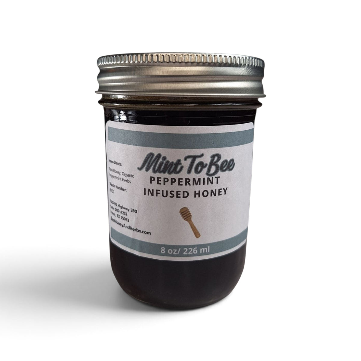 Peppermint infused raw honey in an 8 oz glass jar with a metal lid. 
