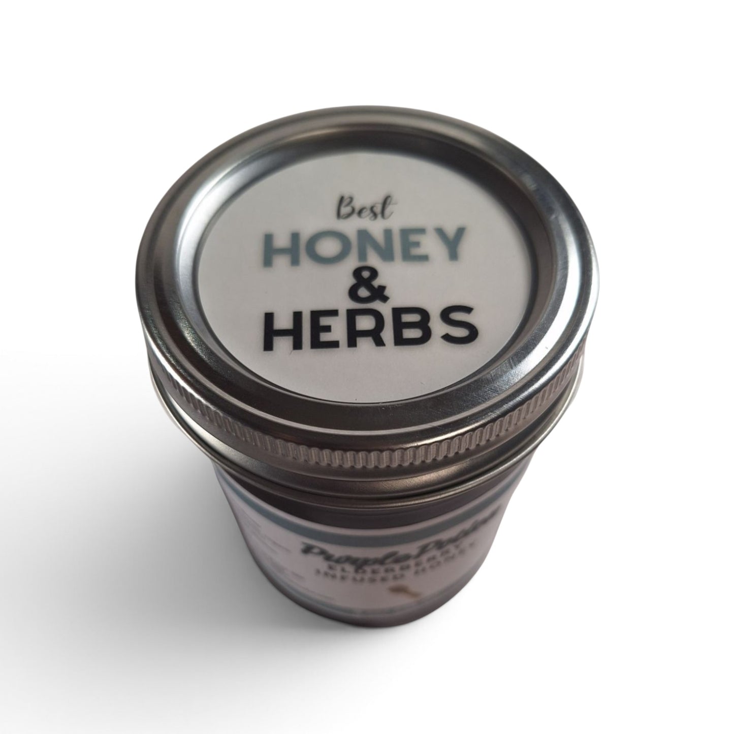  Elderberry infused raw honey jar top down view with a silver lid.