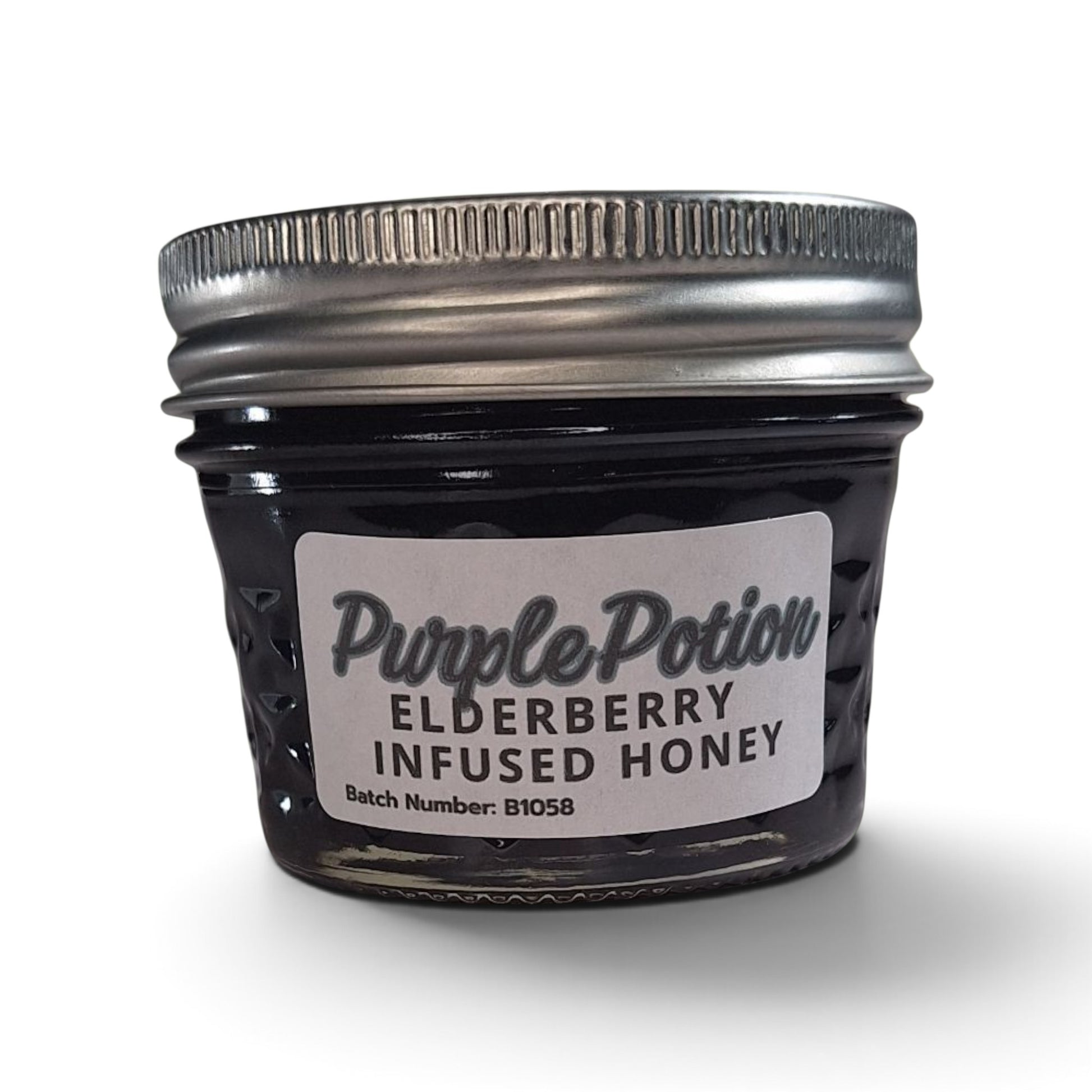  Elderberry infused raw honey in a small glass jar with a silver lid.