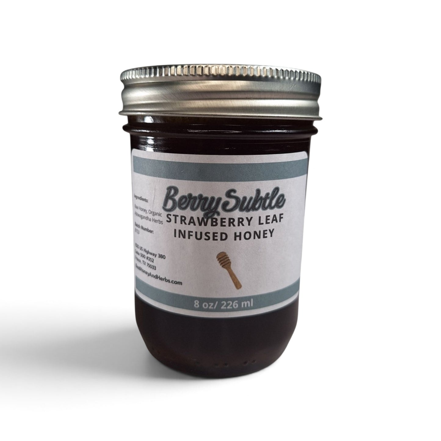  Strawberry leaf infused raw honey in an 8 oz glass jar with a metal lid.