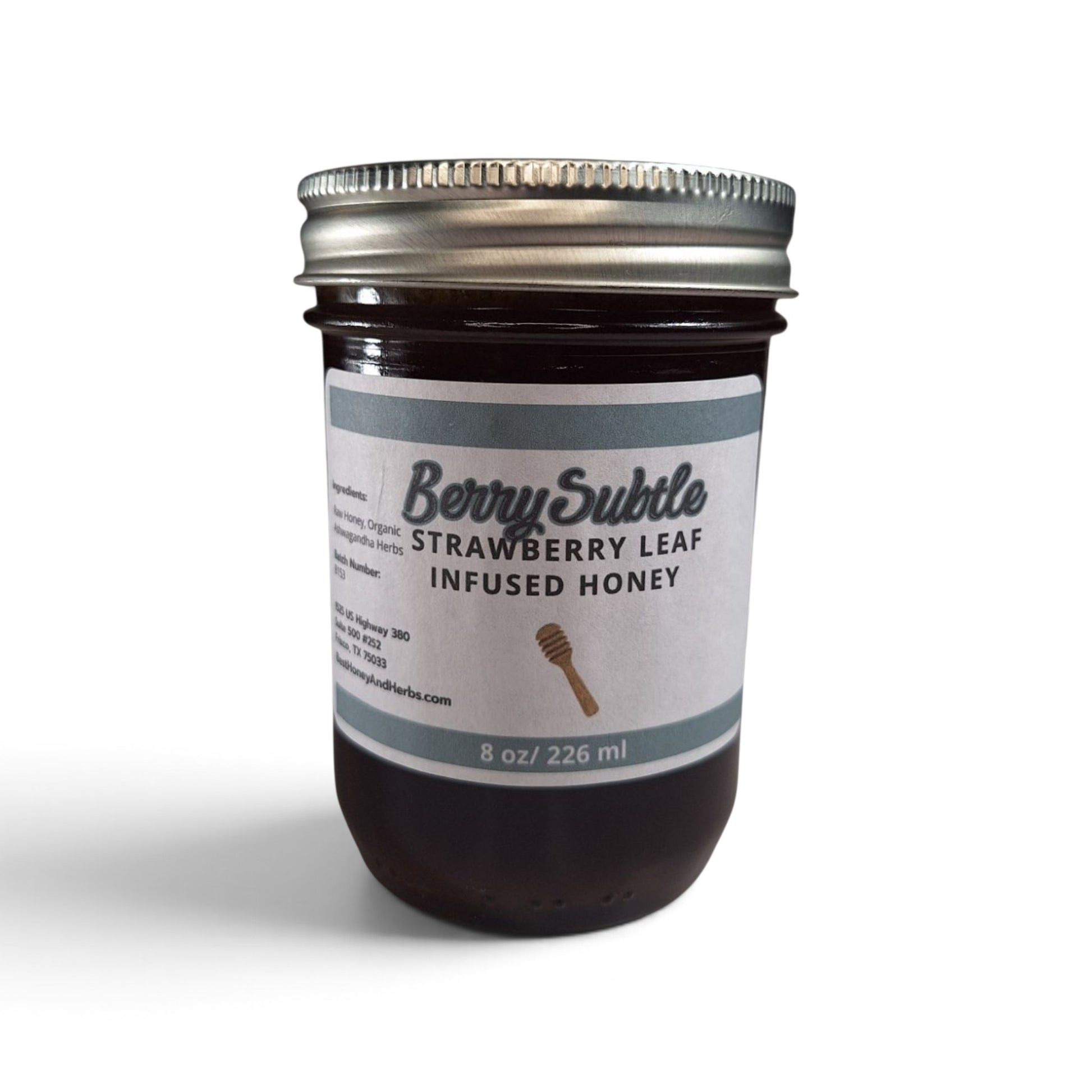  Strawberry leaf infused raw honey in an 8 oz glass jar with a metal lid.