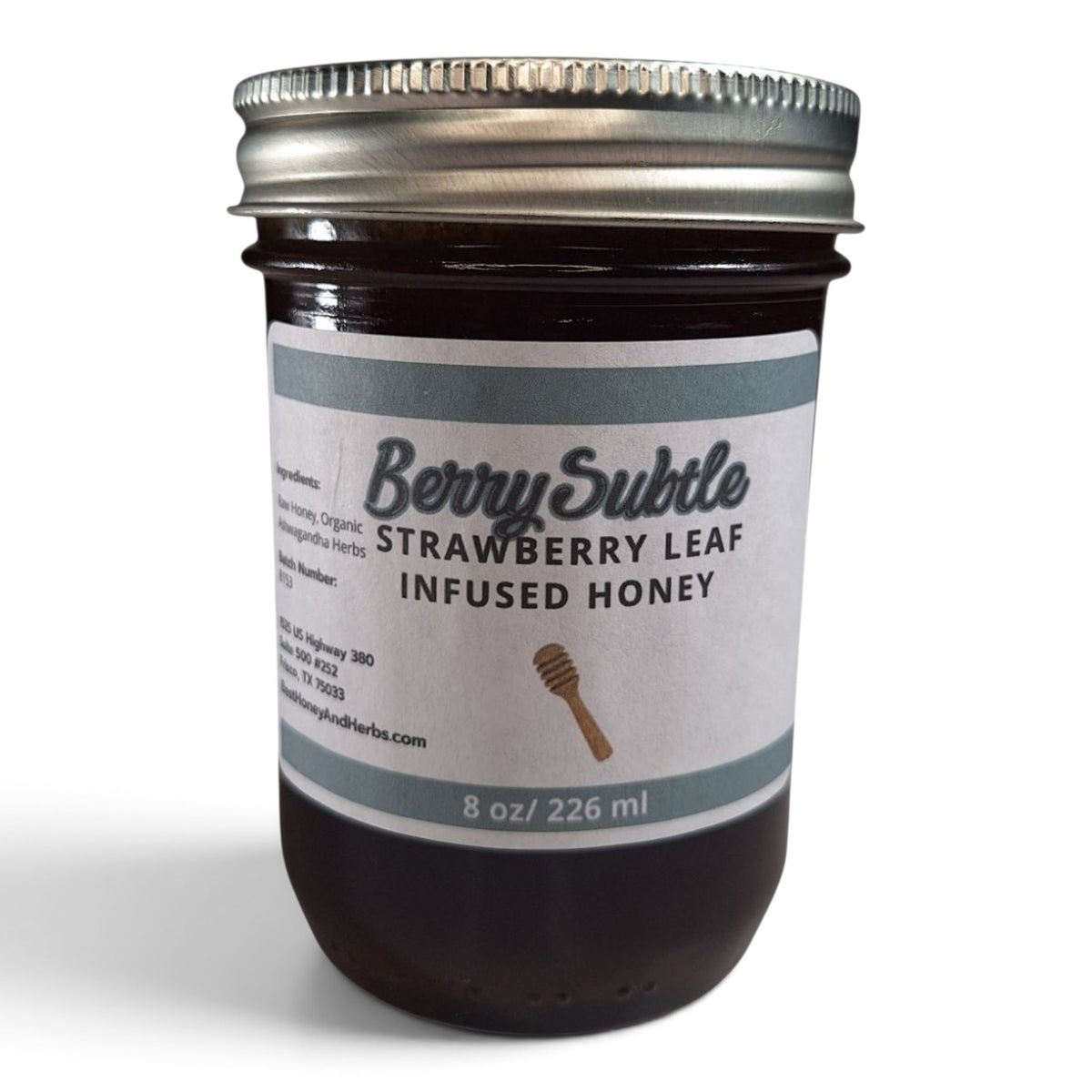  Raw honey infused with organic strawberry leaf in a half pint mason jar with metal lid.