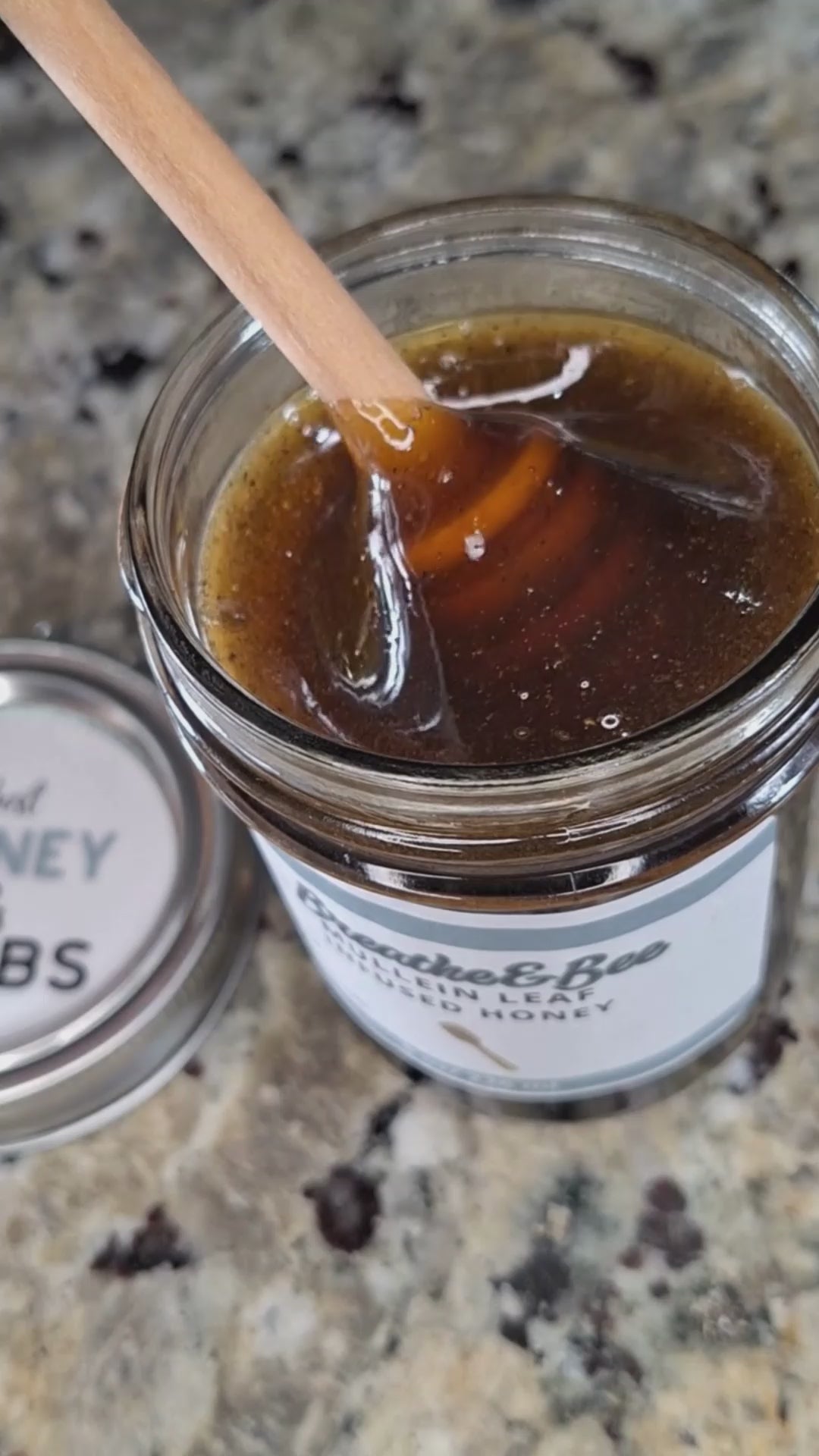  Mullein Leaf infused honey slowly drizzling from a honey dipper.