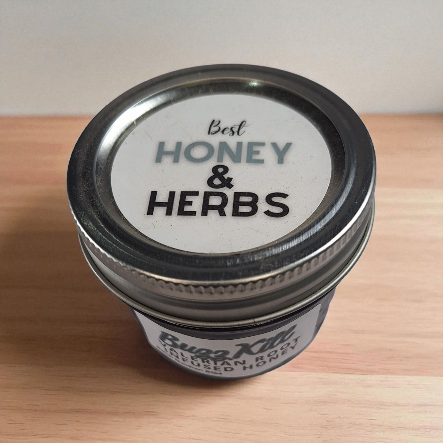 Bird’s-eye 4 oz Valerian Root Infused Honey on a wooden surface; gentle, calming herbal honey for evening tea and cookies.