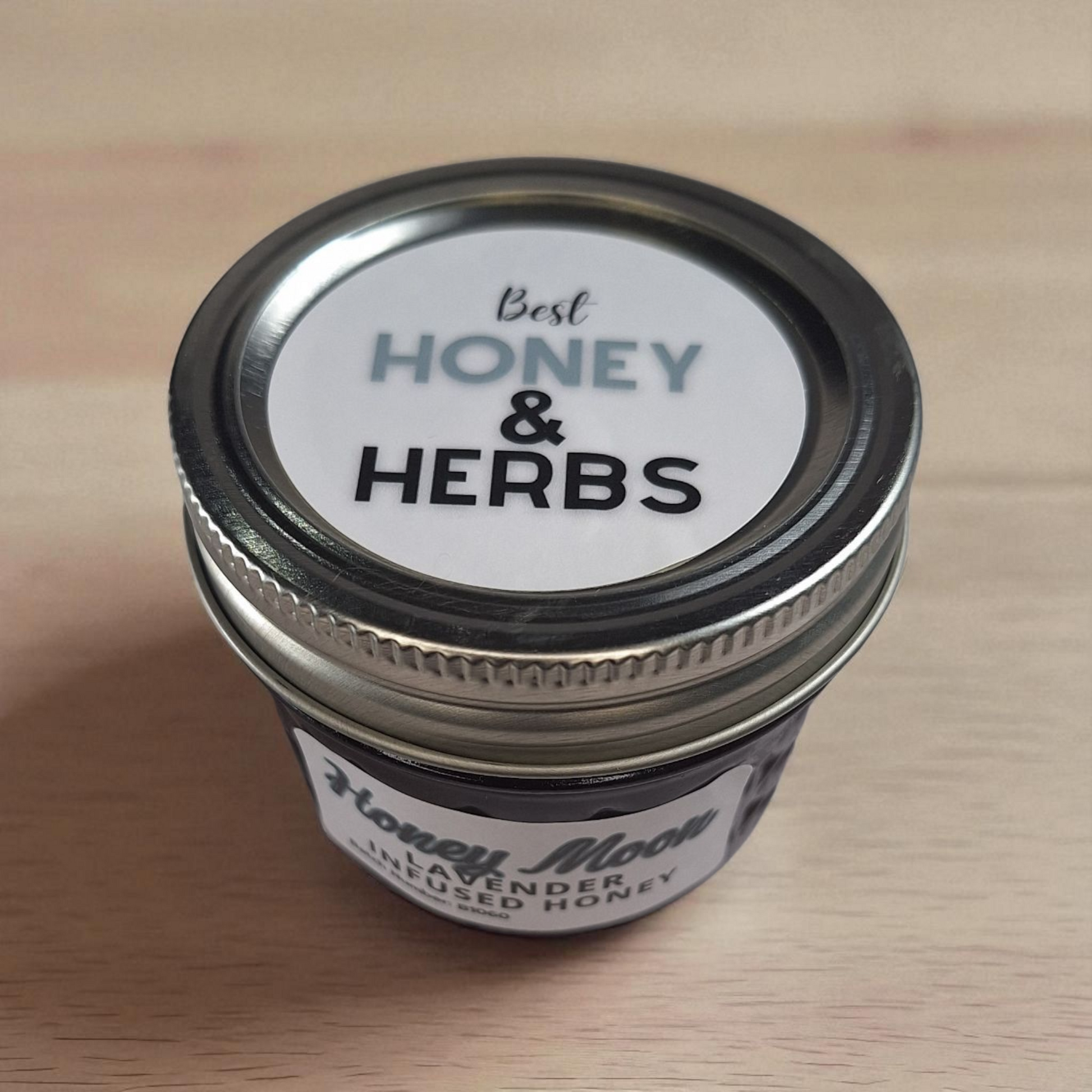 Top view of 4 oz Lavender Infused Honey on pale wood; aromatic herbal honey for scones, lattes, and evening tea.