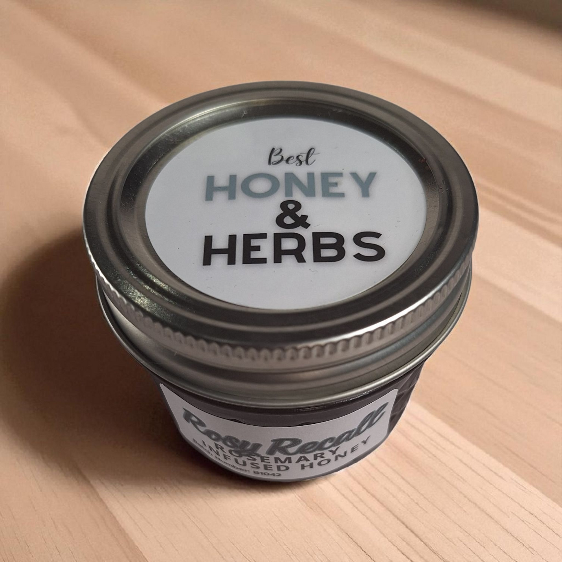 Overhead 4 oz Rosemary Infused Honey on rustic wood; savory herbal honey for roasted vegetables, breads, and goat cheese.